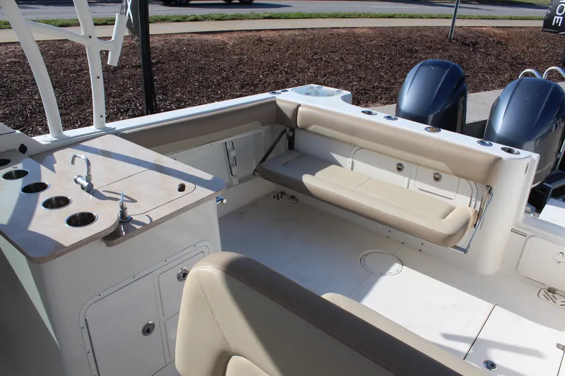 Slide: The Image of 2017 Sailfish 275 DC boat interior with seating, sink, and dual engines. - 10