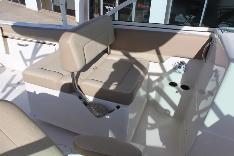 Slide: The Image of 2017 Sailfish 275 DC boat interior with beige seating and cup holders. - 12