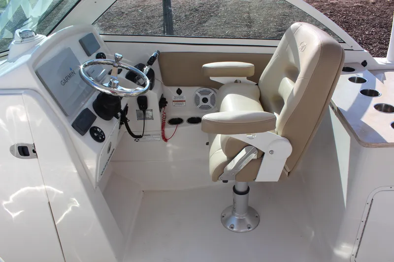 Slide: The Image of 2017 Sailfish 275 DC helm with Garmin display and beige captain's chair. - 13