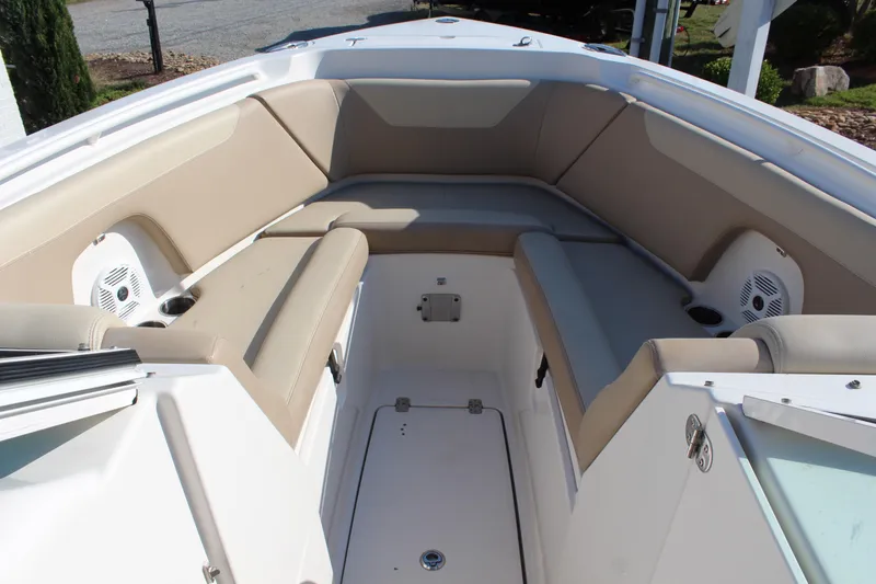 Slide: The Image of Interior view of 2017 Sailfish 275 DC boat with beige seating and speakers. - 15