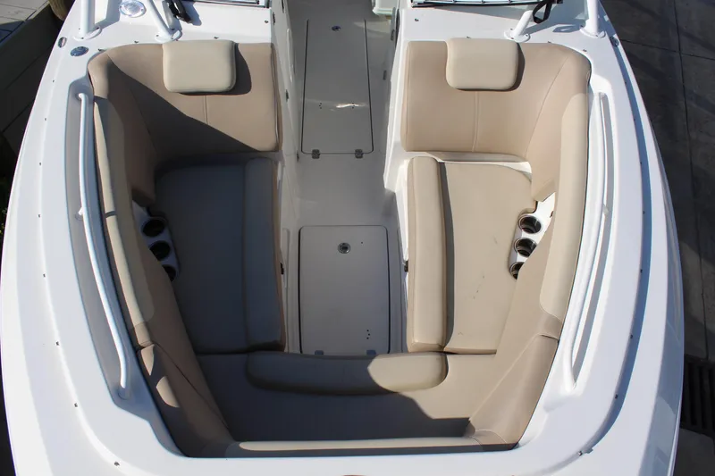 Slide: The Image of 2017 Sailfish 275 DC boat interior with beige seating and cup holders. - 16