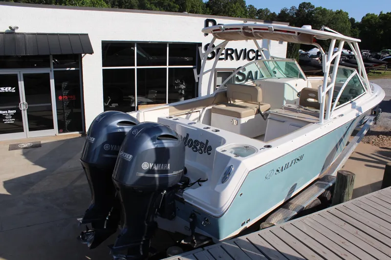 Slide: The Image of 2017 Sailfish 275 DC boat with twin Yamaha engines at a service center. - 3