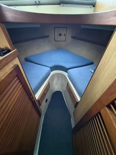 Slide: The Image of Interior of a 1984 Bertram 30 yacht with blue cushions. - 12