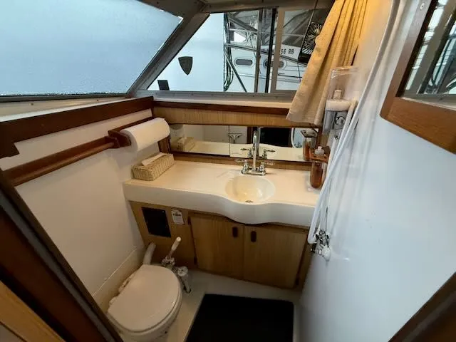 Slide: The Image of Interior view of a 1984 Bertram 30 bathroom with sink and toilet. - 13