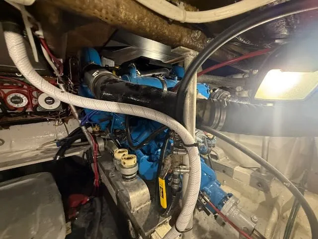 Slide: The Image of Engine room of a 1984 Bertram 30 boat with blue machinery. - 16