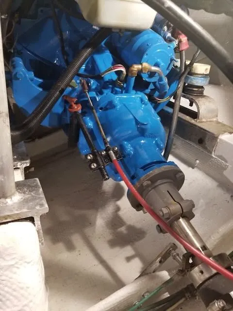 Slide: The Image of Engine compartment of a 1984 Bertram 30 boat with blue engine. - 19
