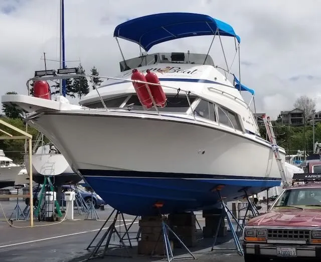 Slide: The Image of 1984 Bertram 30 boat docked on stands in harbor. - 29