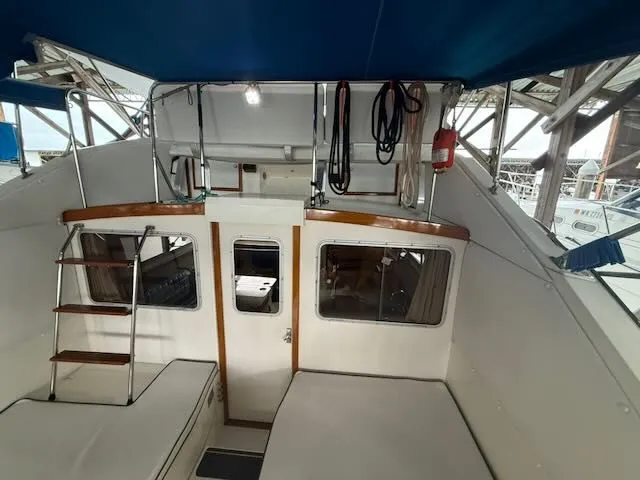 Slide: The Image of Interior view of a 1984 Bertram 30 yacht with blue canopy. - 3