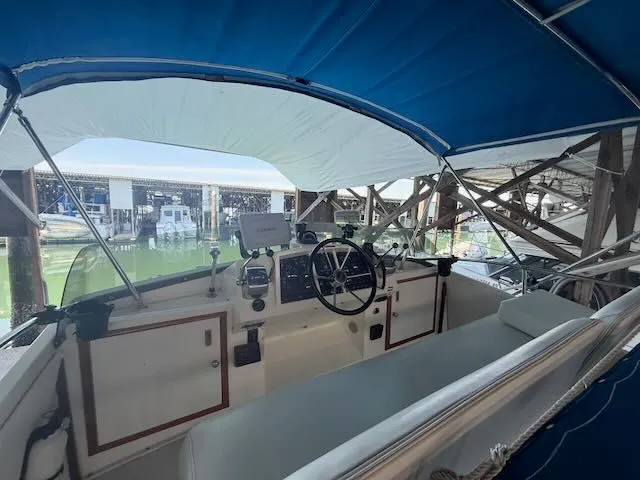 Slide: The Image of Interior view of a 1984 Bertram 30 boat with blue canopy. - 5