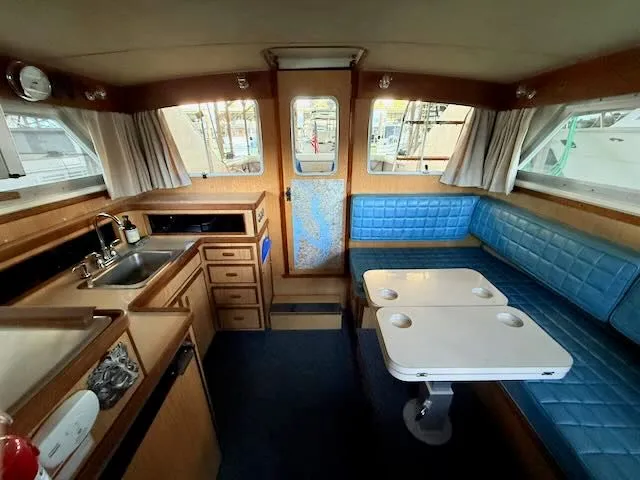 Slide: The Image of Interior of a 1984 Bertram 30 yacht with blue seating. - 8