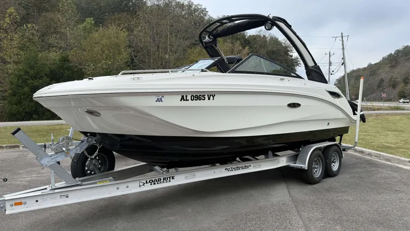 The Image of 2021 Sea Ray SDX250 boat parked on trailer outdoors. - 1