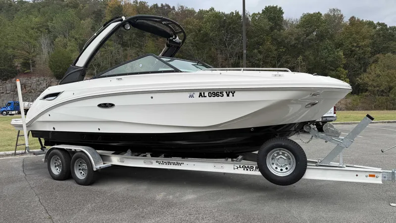 Slide: The Image of 2021 Sea Ray SDX250 boat on trailer parked outdoors. - 16