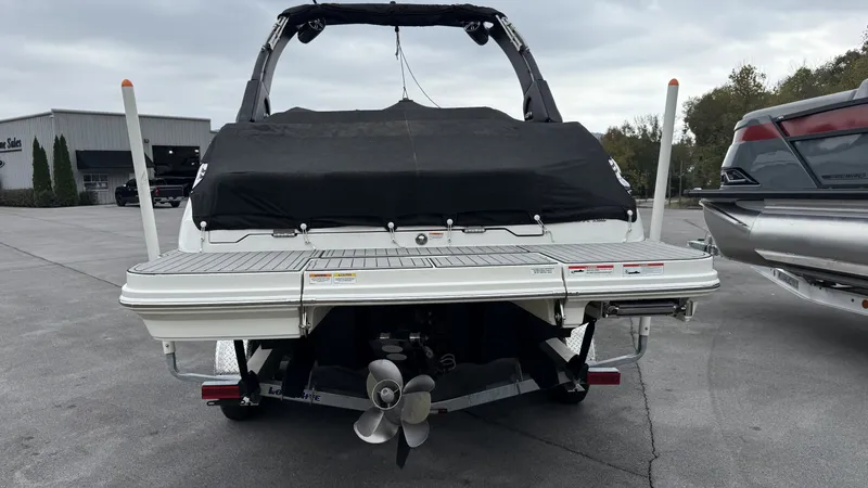 Slide: The Image of Rear view of a 2021 Sea Ray SDX250 boat in a parking lot. - 18