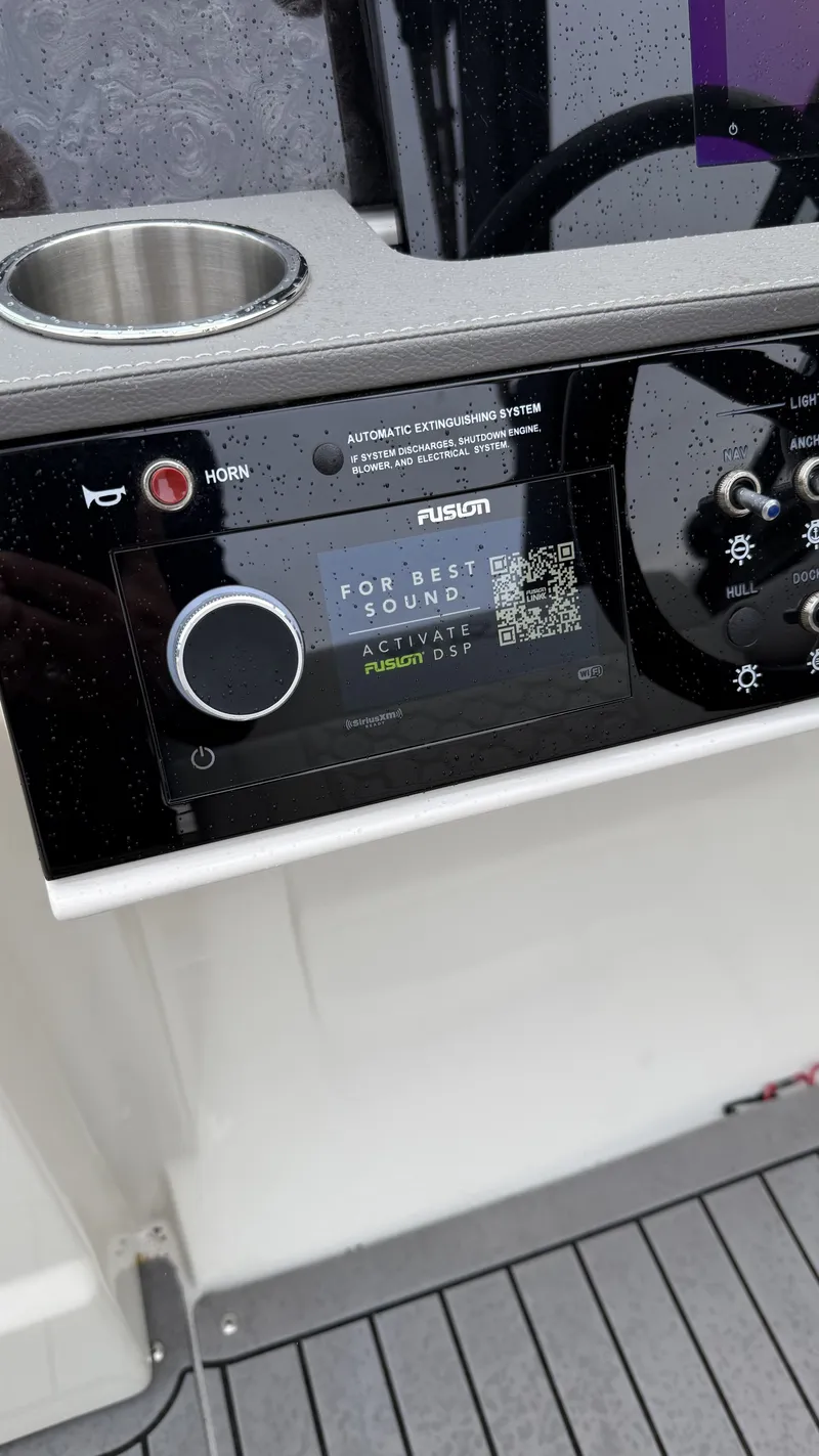 Slide: The Image of Dashboard of a Sea Ray SDX250 boat featuring Fusion DSP system. - 3
