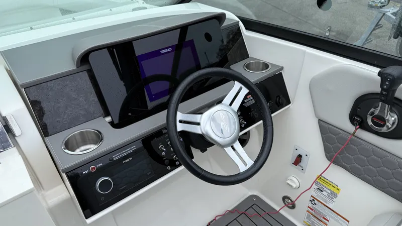Slide: The Image of 2021 Sea Ray SDX250 helm with Simrad display and controls. - 7