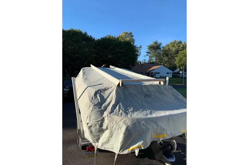 Slide: The Image of Covered 2011 Stingray 235 LR boat on trailer in residential area. - 10