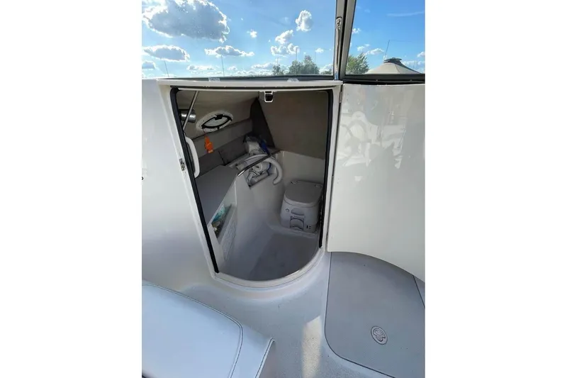 Slide: The Image of Interior cabin view of a 2011 Stingray 235 LR boat under a sunny sky. - 7