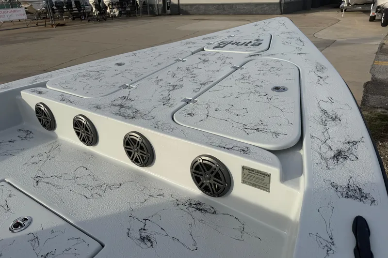 Slide: The Image of 2026 Skuta Vista 24 boat deck with stylish black marbling and speaker system. - 10