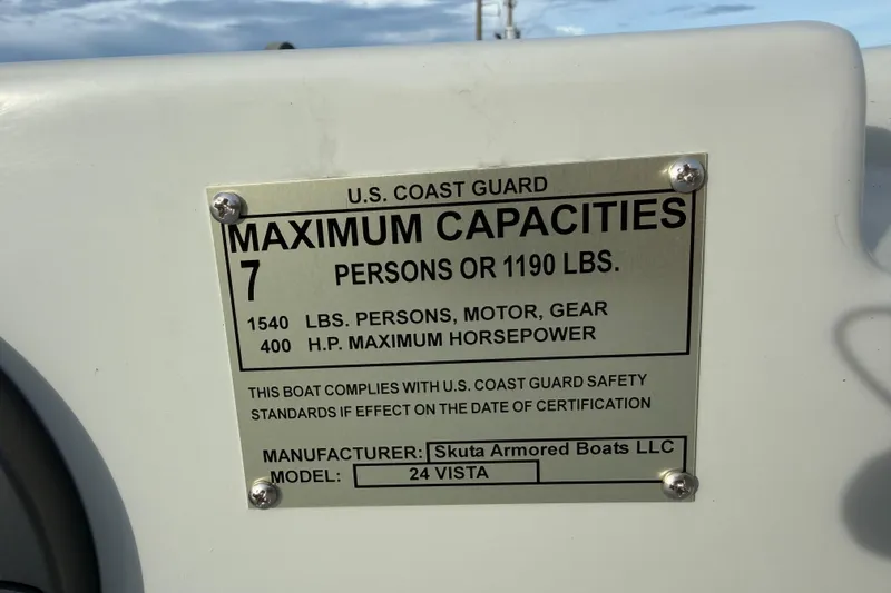 Slide: The Image of Plaque on Skuta Vista 24 boat showing maximum capacities and compliance details. - 11