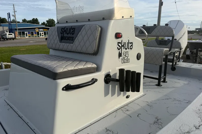 Slide: The Image of Skuta Vista 24 boat interior with cushioned seating and rod holders, 2026 model. - 3