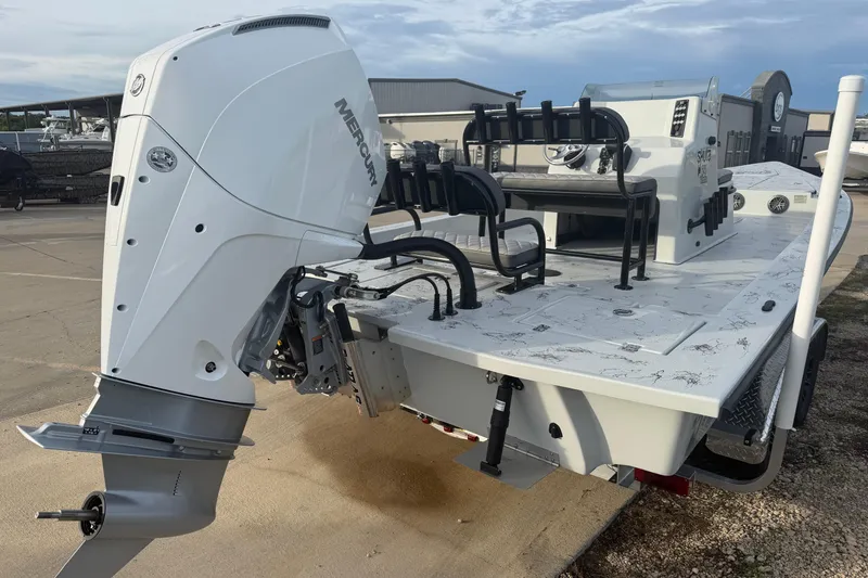 Slide: The Image of 2026 Skuta Vista 24 boat with Mercury outboard engine, docked outdoors. - 6