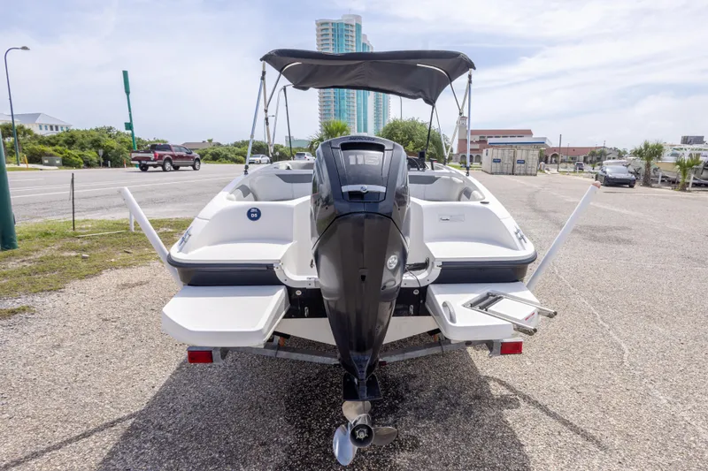 Slide: The Image of 2015 Bayliner Element XL boat with outboard motor, parked on a sunny day. - 12