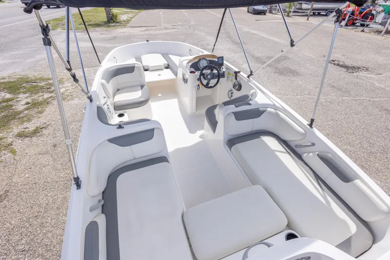 Slide: The Image of 2015 Bayliner Element XL boat interior with seating and steering console. - 20