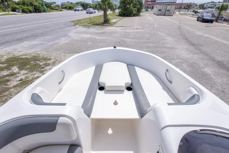 Slide: The Image of 2015 Bayliner Element XL boat interior with seating, parked near a road. - 26