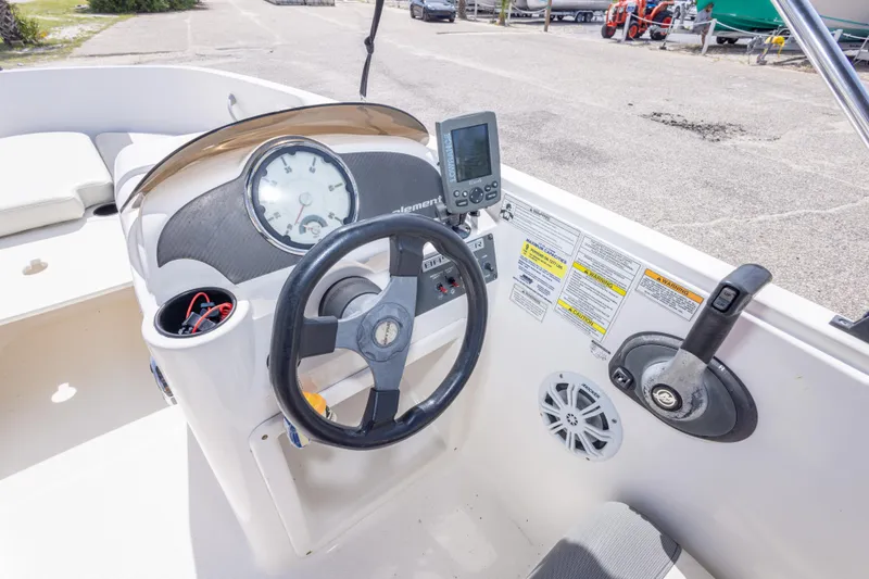 Slide: The Image of 2015 Bayliner Element XL boat dashboard with steering wheel and control panel. - 30