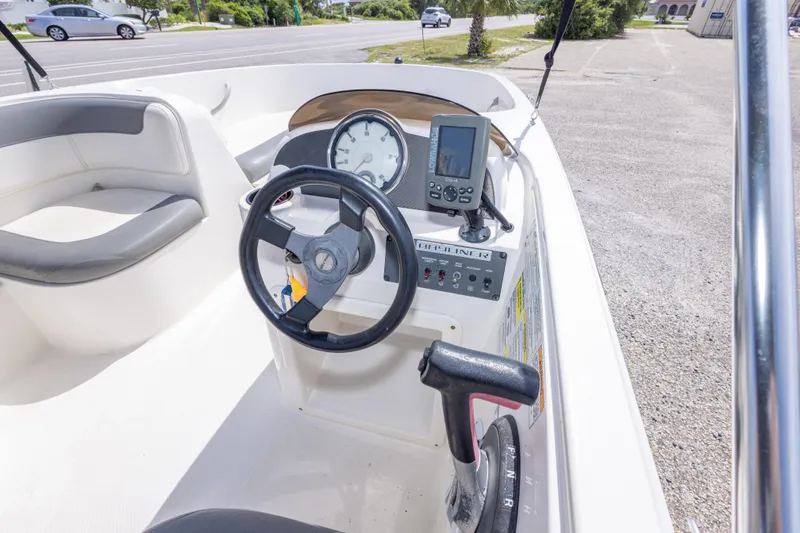 Slide: The Image of 2015 Bayliner Element XL boat dashboard with steering wheel and navigation equipment. - 31