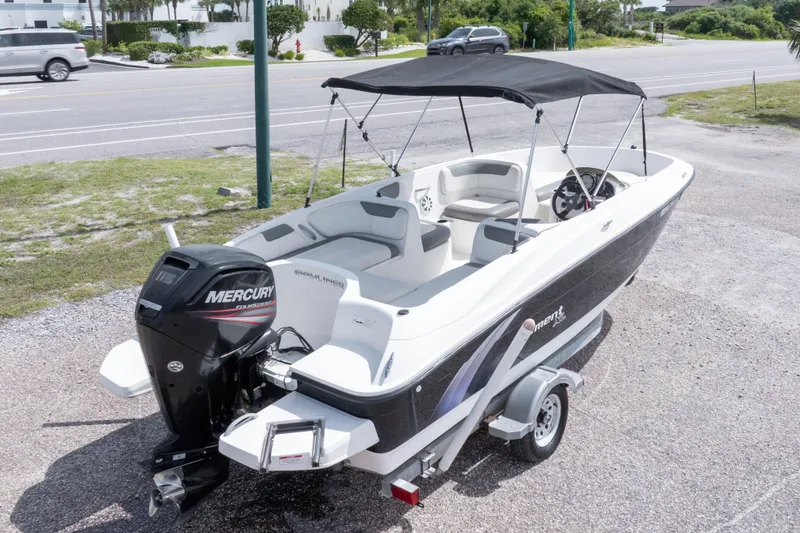 Slide: The Image of 2015 Bayliner Element XL boat with Mercury outboard engine, parked on a trailer. - 36