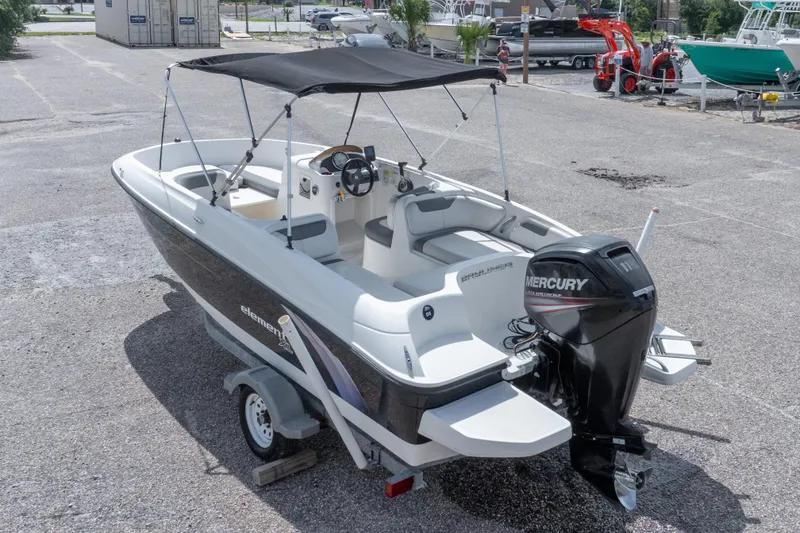 Slide: The Image of 2015 Bayliner Element XL boat with Mercury outboard motor on a trailer. - 38