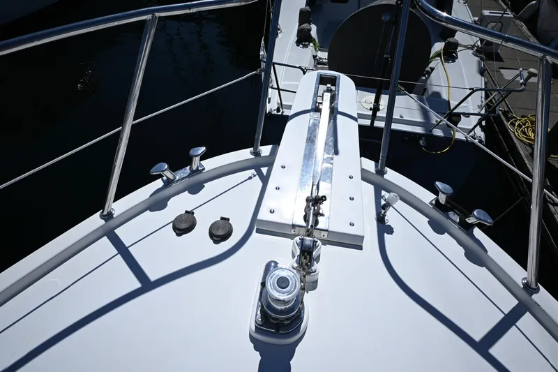 Slide: The Image of Bow view of 1999 McKinna 47 Sedan yacht with polished railings and deck fittings. - 11