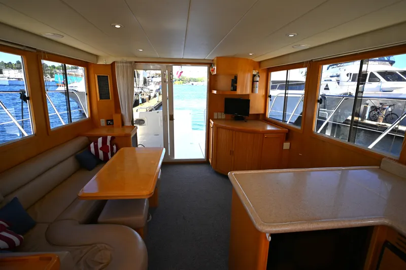 Slide: The Image of Interior of a 1999 McKinna 47 Sedan yacht with cozy seating and waterfront views. - 26