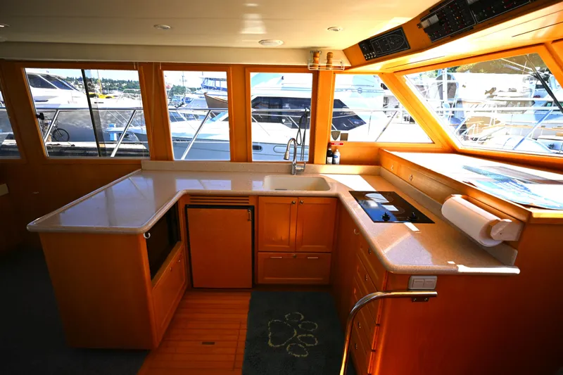 Slide: The Image of Interior of 1999 McKinna 47 Sedan yacht with modern kitchen and large windows. - 27