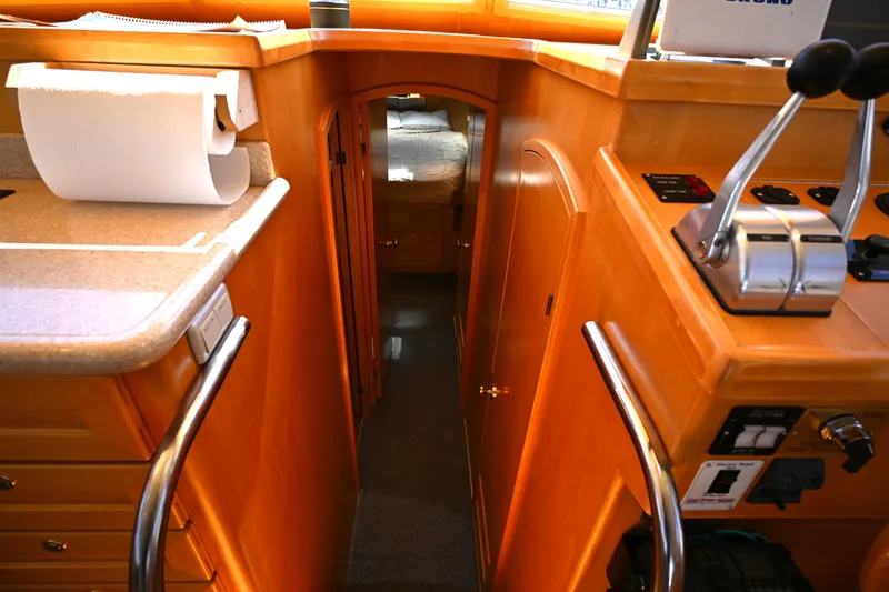 Slide: The Image of Interior view of a 1999 McKinna 47 Sedan yacht, featuring a cozy cabin hallway. - 29