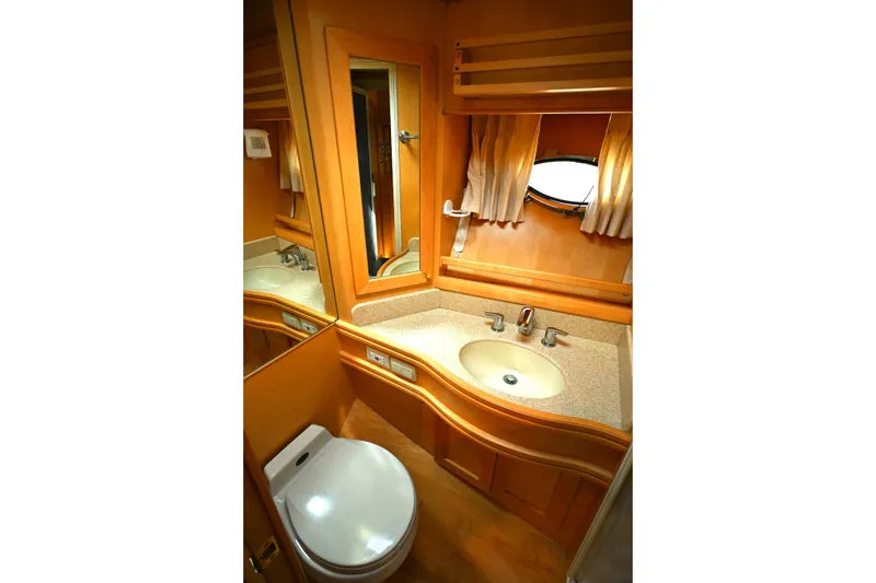 Slide: The Image of Bathroom interior of 1999 McKinna 47 Sedan yacht with sink, mirror, and toilet. - 36