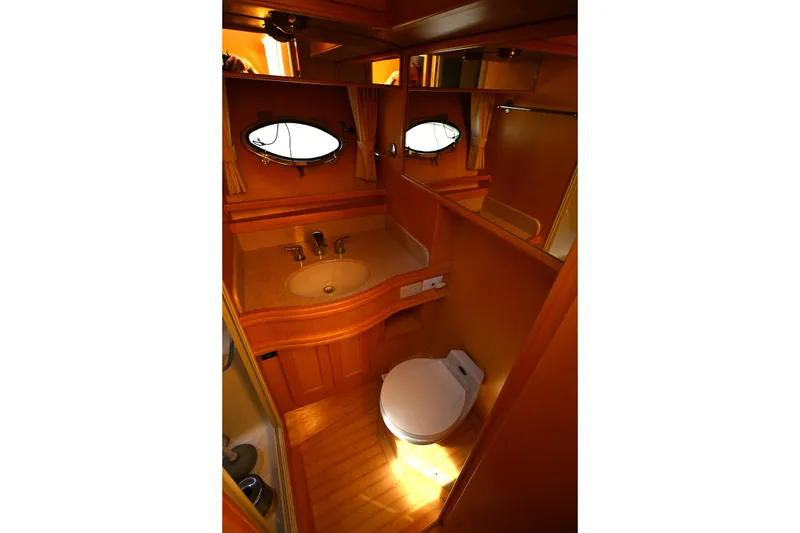 Slide: The Image of Bathroom interior of 1999 McKinna 47 Sedan yacht, featuring sink and toilet. - 37