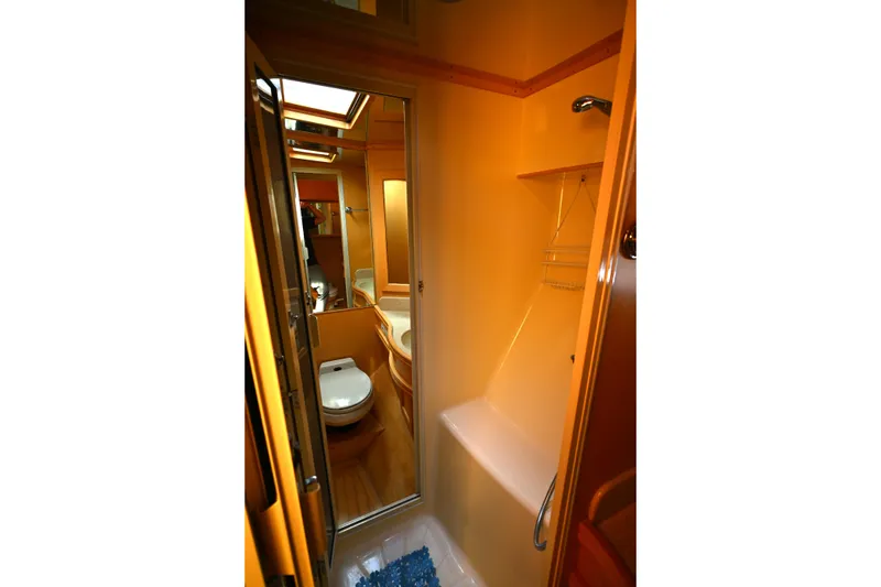Slide: The Image of Bathroom interior of 1999 McKinna 47 Sedan yacht, featuring shower and toilet. - 38