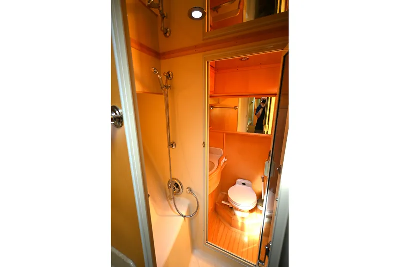 Slide: The Image of Bathroom interior of 1999 McKinna 47 Sedan yacht, featuring shower and toilet. - 39