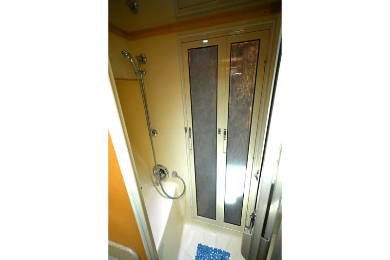 Slide: The Image of Shower area in 1999 McKinna 47 Sedan yacht with sliding doors and handheld showerhead. - 40