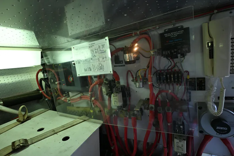 Slide: The Image of Electrical panel of a 1999 McKinna 47 Sedan yacht, featuring wiring and components. - 52