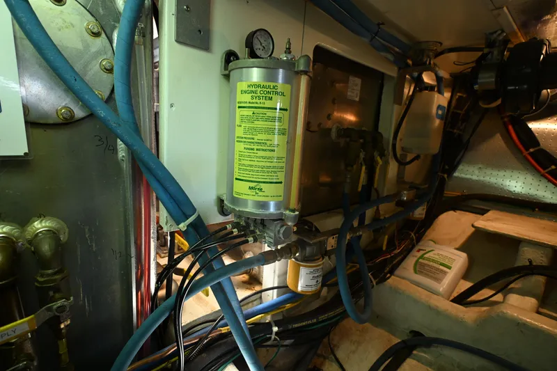 Slide: The Image of Engine room of 1999 McKinna 47 Sedan with hydraulic control system. - 58