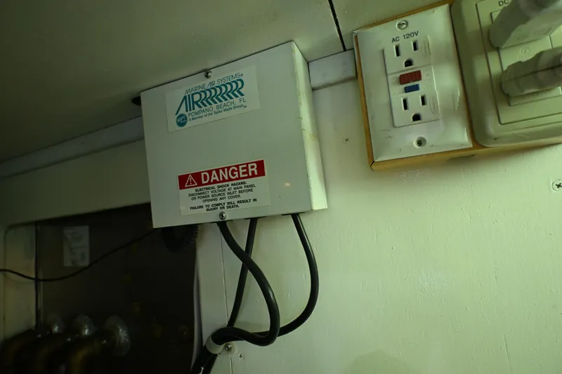 Slide: The Image of Electrical panel with warning label on 1999 McKinna 47 Sedan boat. - 63