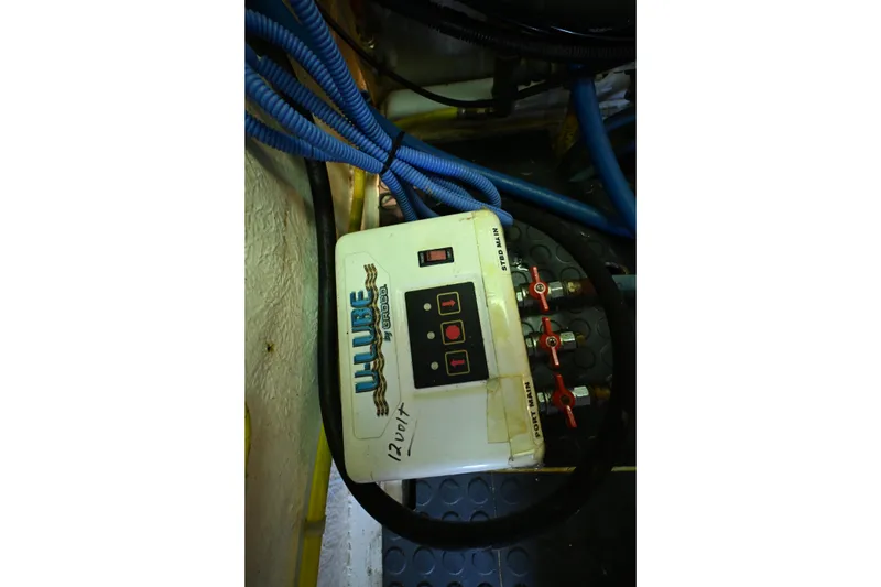 Slide: The Image of Engine room of 1999 McKinna 47 Sedan with oil lubrication system and cables. - 64