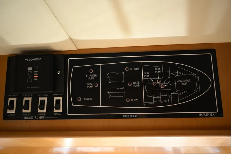 Slide: The Image of Control panel of a 1999 McKinna 47 Sedan boat, showing bilge pump switches. - 66