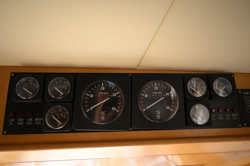 Slide: The Image of Instrument panel of a 1999 McKinna 47 Sedan yacht, featuring various gauges and indicators. - 69