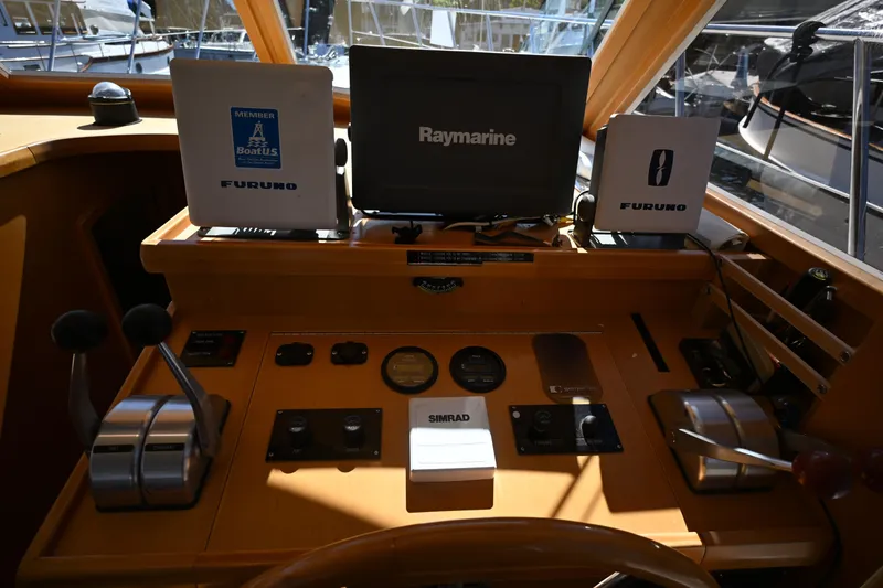 Slide: The Image of 1999 McKinna 47 Sedan helm with Raymarine and Furuno navigation equipment. - 71
