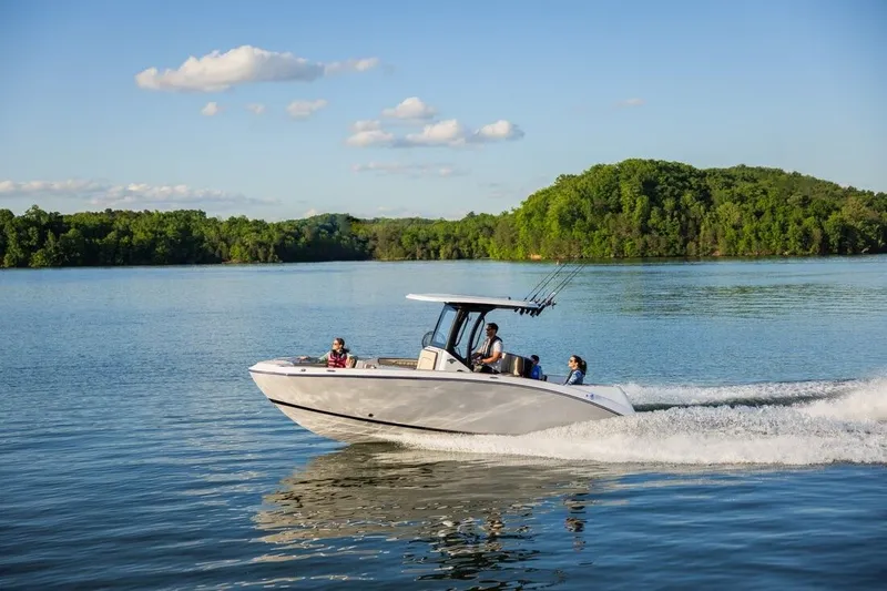 Slide: The Image of Yamaha 255 FSH Sport H 2026 cruising on a serene lake. - 23