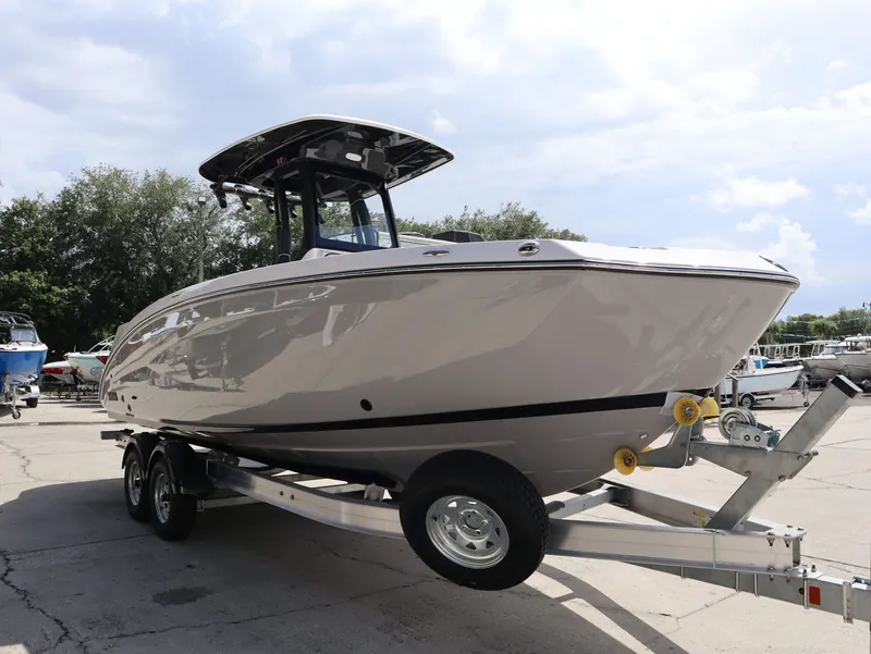 Slide: The Image of 2026 Yamaha Boats 255 FSH Sport H on trailer outdoors. - 4